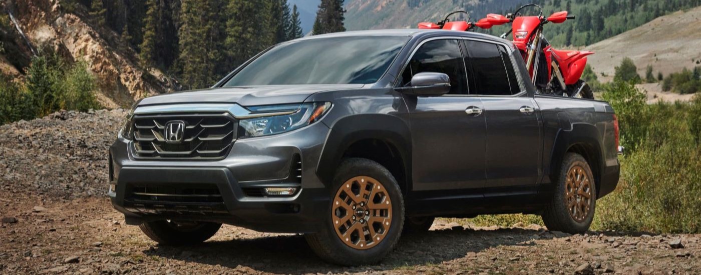 A grey 2021 Honda Ridgeline is shown from the front at an angle after leaving a dealer that handles Honda truck service.