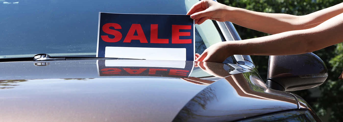 car for sale sign on a used vehicle