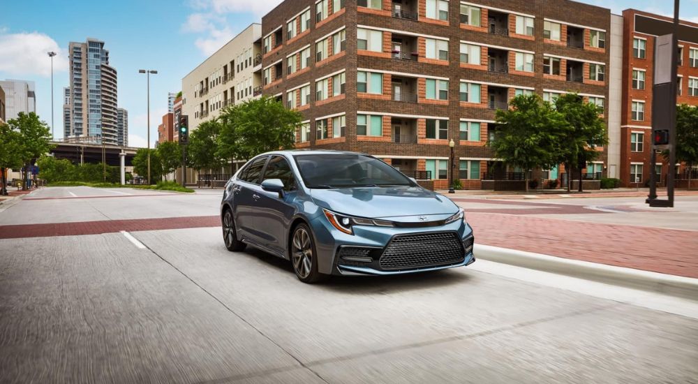 Blue 2022 Toyota Corolla XSE driving through a city