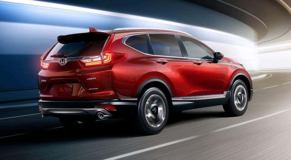 A red 2017 Honda CR-V is shown driving in a tunnel.