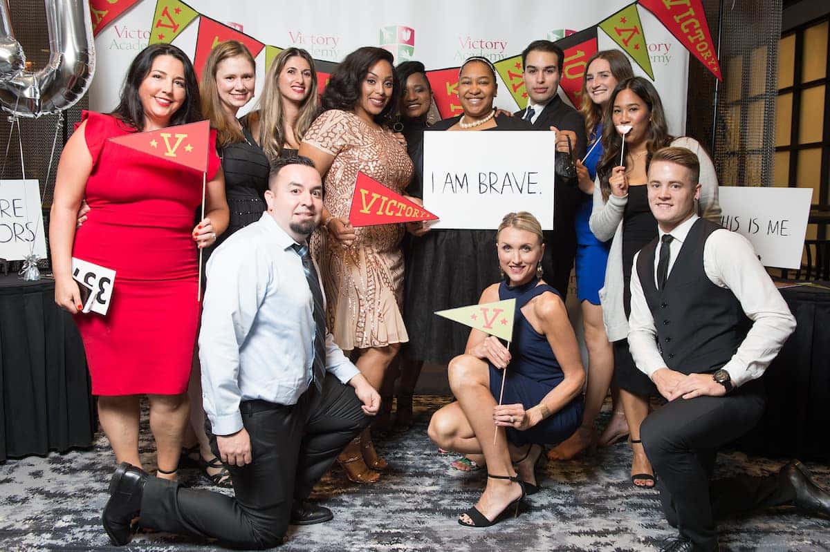 Victory Academy supporters posing at a celebration event