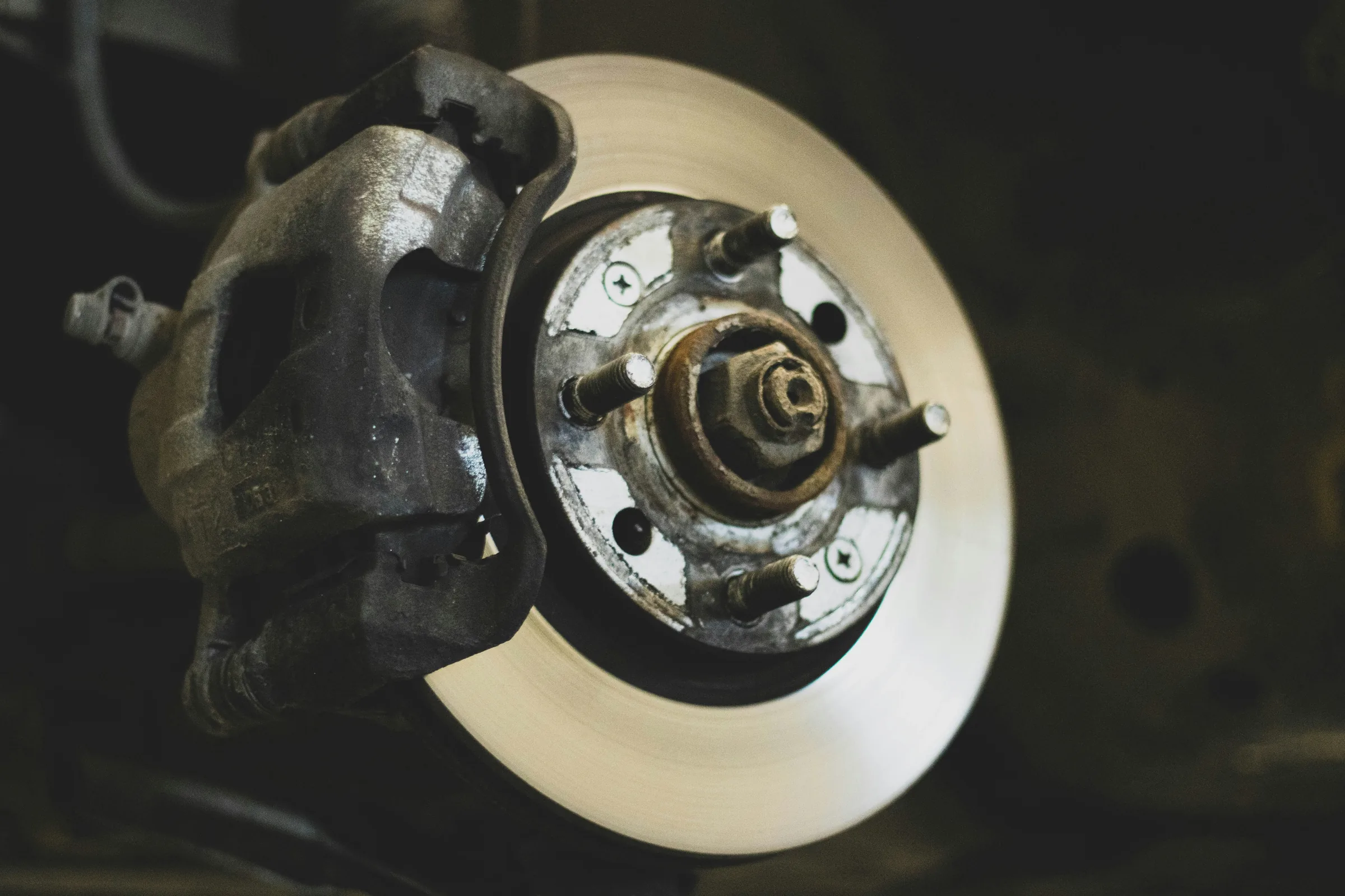 Close-up of a vehicle's brake rotor and caliper during a service inspection. Automotive Brake Service Near Kansas City