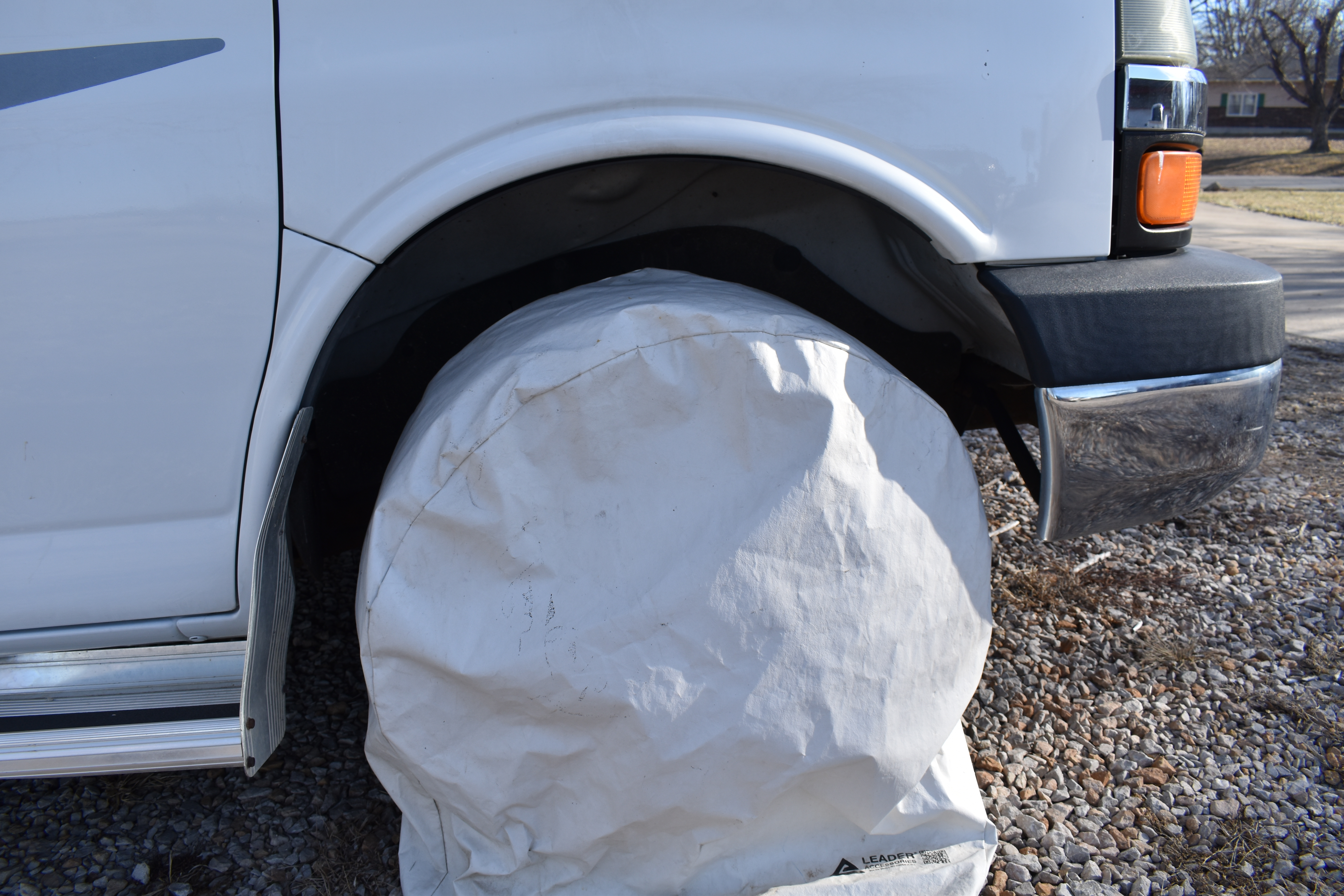 medium shot of a RV tire with a white cover on it