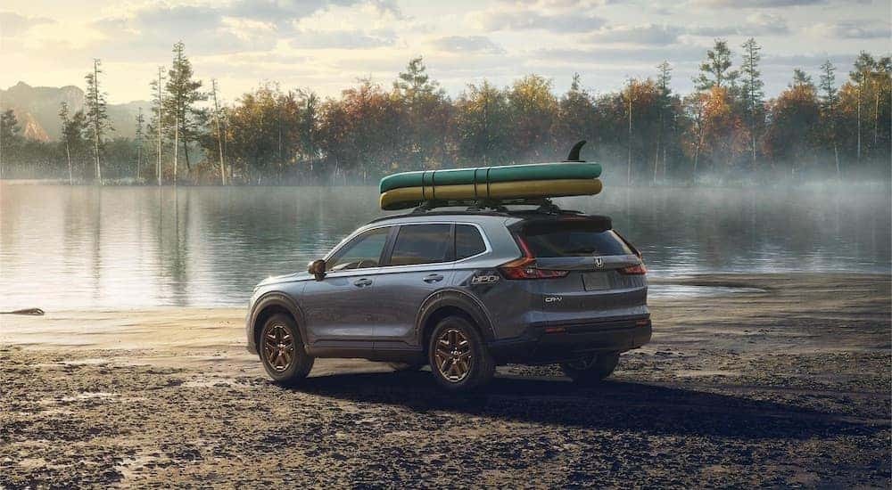 Grey 2023 Honda CR-V Hybrid for sale parked by a lake