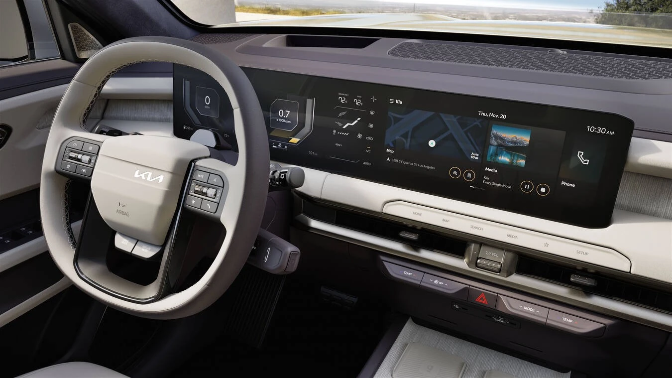 Widescreen digital cockpit display in a 2027 Kia Telluride HEV SXP showing 0 mph, a 0.7 x1000 rpm gauge, dual-zone climate set to 72°F on both sides, a 101 mi range readout, a navigation map centered on 1201 S Figueroa St in Los Angeles, and a media panel playing "Every Single Move" by Kia.