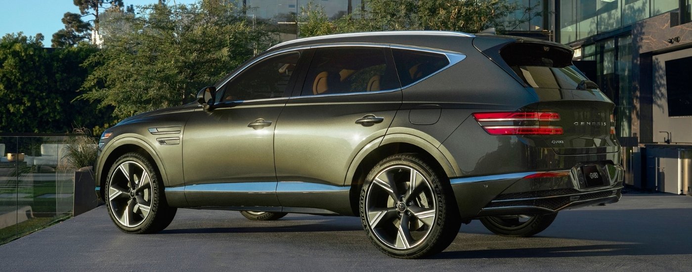 Green 2025 Genesis GV80 SUV parked on a driveway