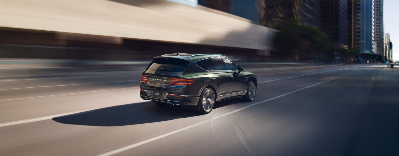 Black 2025 Genesis GV80 driving to a Genesis dealer in Montgomery