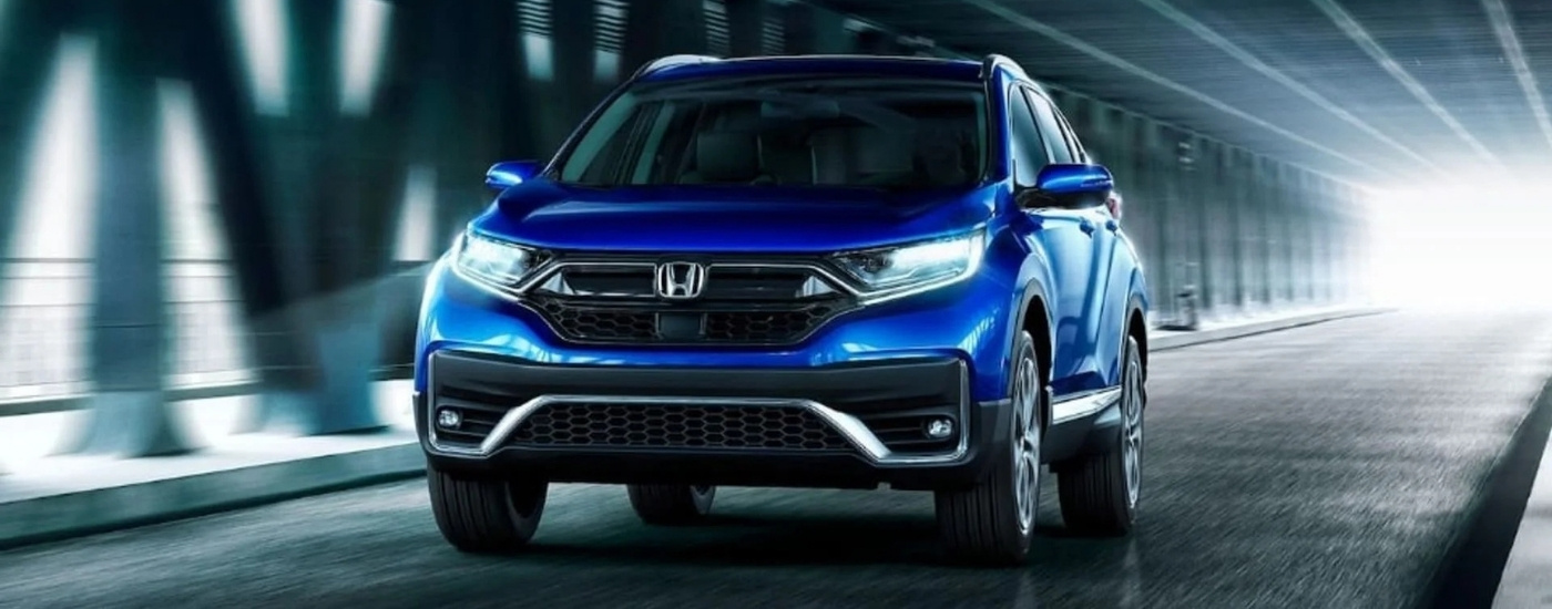 Blue 2021 Honda CR-V Touring driving in a dark tunnel