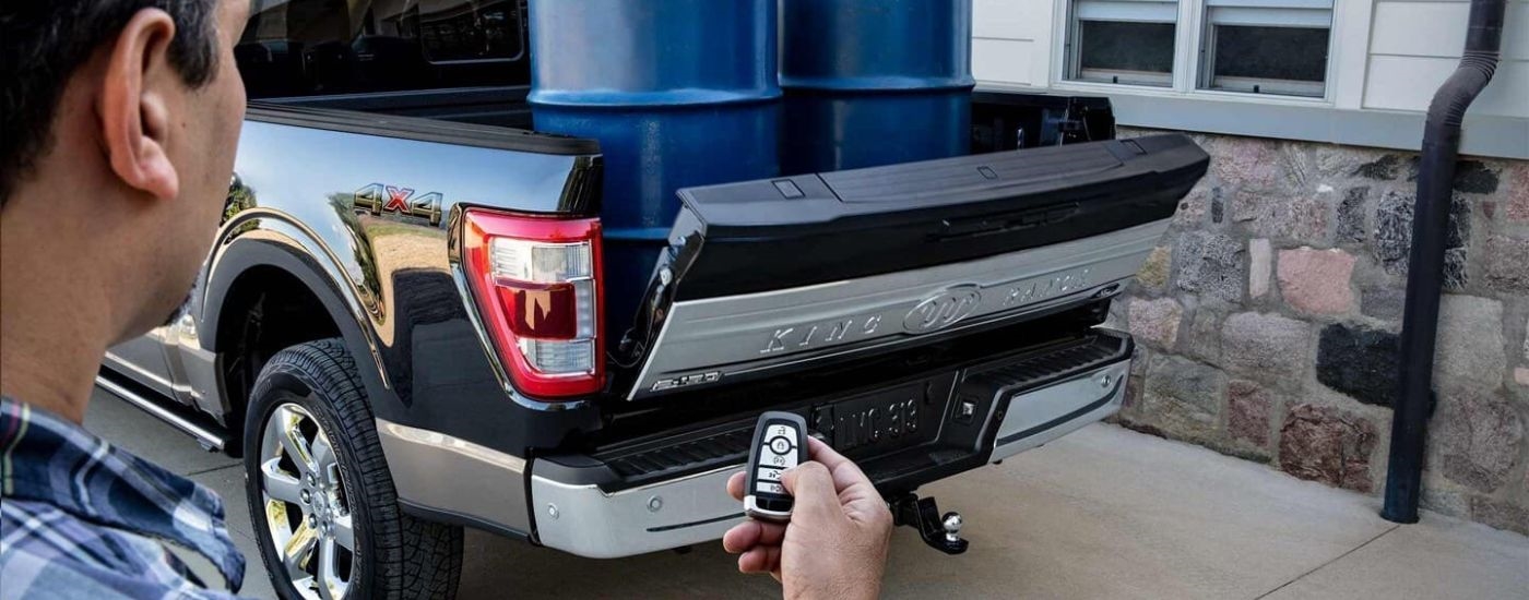Blue barrels in the bed of a black 202 Ford F-150.