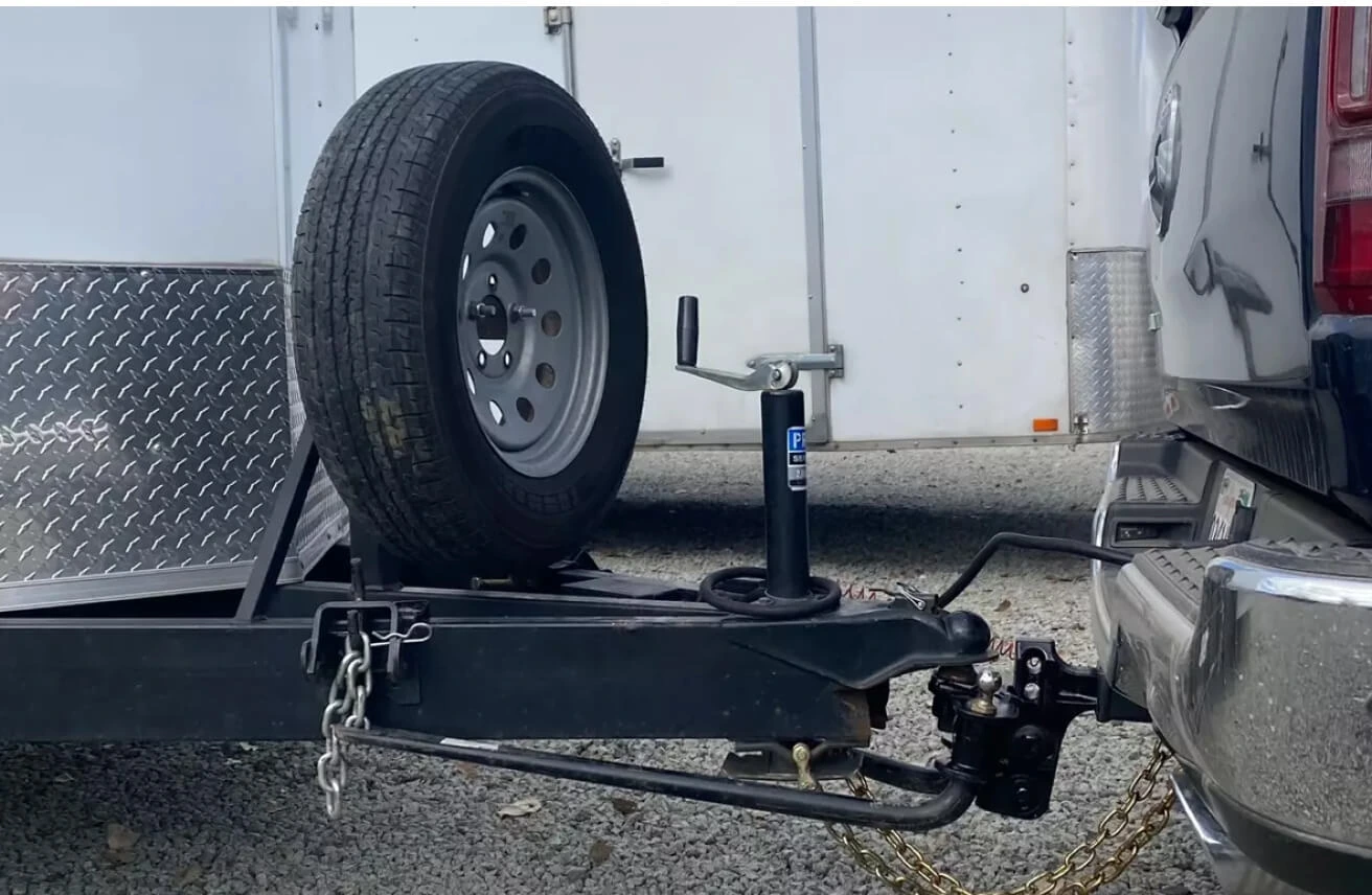 Close-up of a travel trailer attached to an SUV trailer hitch.
