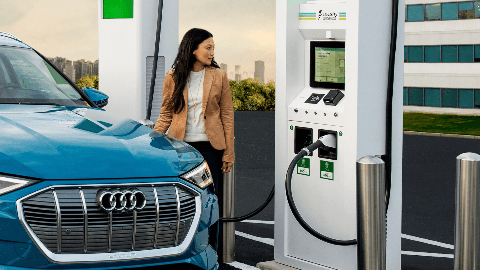 A woman charging her new Audi EV.