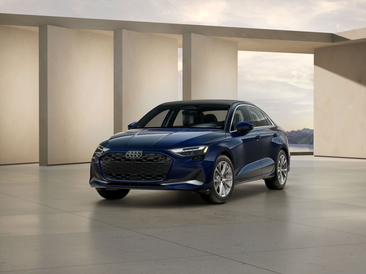 Navy blue 2026 Audi A3 Premium Plus sedan, front three-quarter view in an Audi showroom