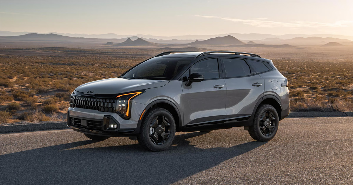 2026 Kia Sportage parked on a paved roadside overlook, with a vast desert landscape and rolling hills