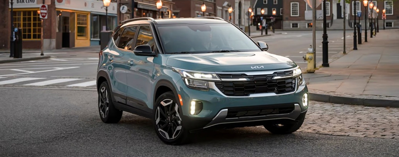 Blue 2025 Kia Seltos SX driving to a Kia dealer