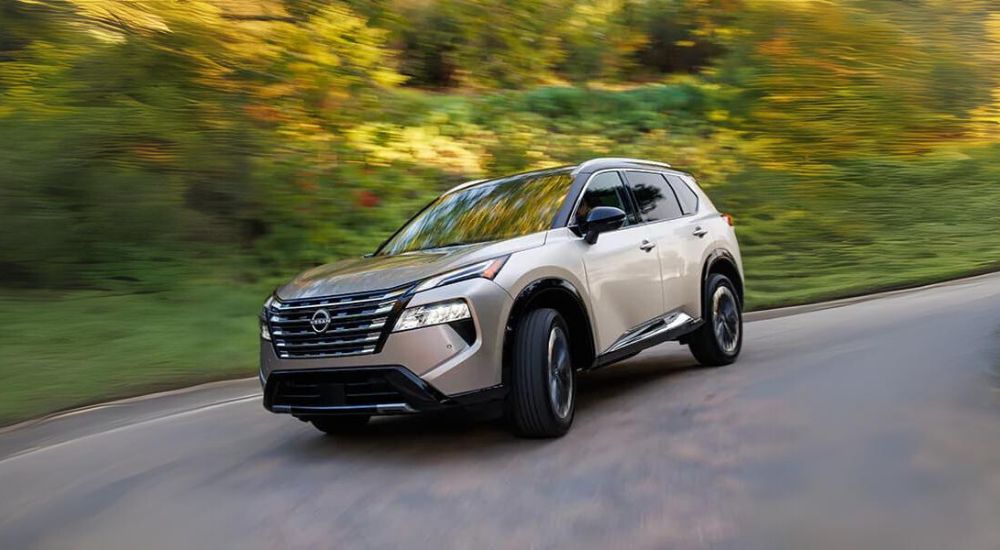 Tan 2025 Nissan Rogue rounding a corner