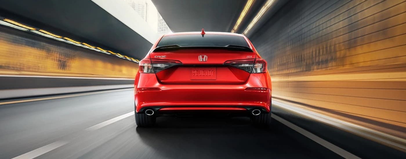 Red 2024 Honda Civic Si driving through a tunnel