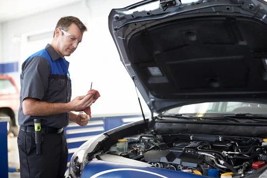 Technician performing an oil change and tire service