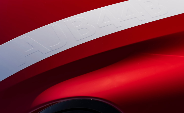 Close up on sport stripes spanning the bonnet, roof and boot on the 2026 JCW 2 Door roof and mirror caps. 