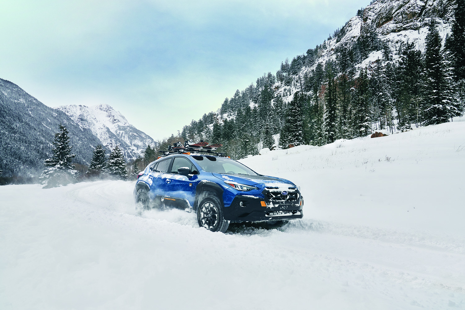 2026 Subaru Crosstrek driving on a snowy mountain road