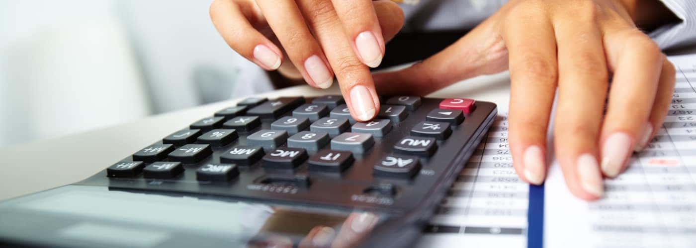 finance paperwork with giant calculator