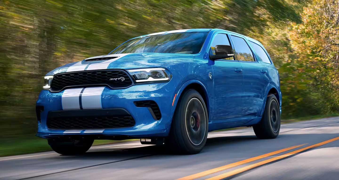 a blue car driving on the road.