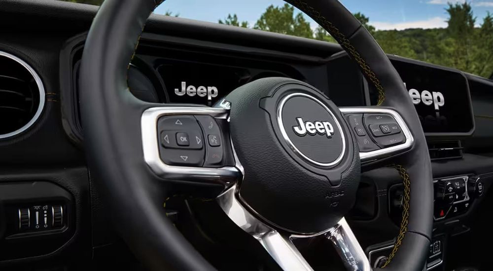 A close up shows the steering wheel in a 2024 Jeep Wrangler 4xe.