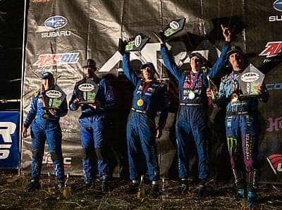 Subaru rally team celebrating on the podium