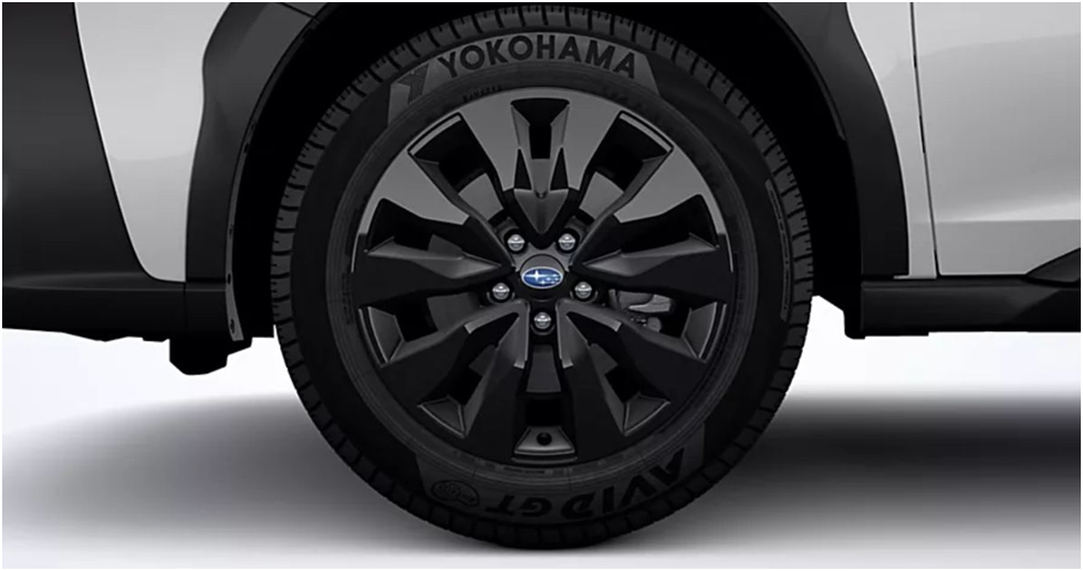 Black-finish alloy wheel with a Yokohama tire on a white Subaru Outback Onyx Edition