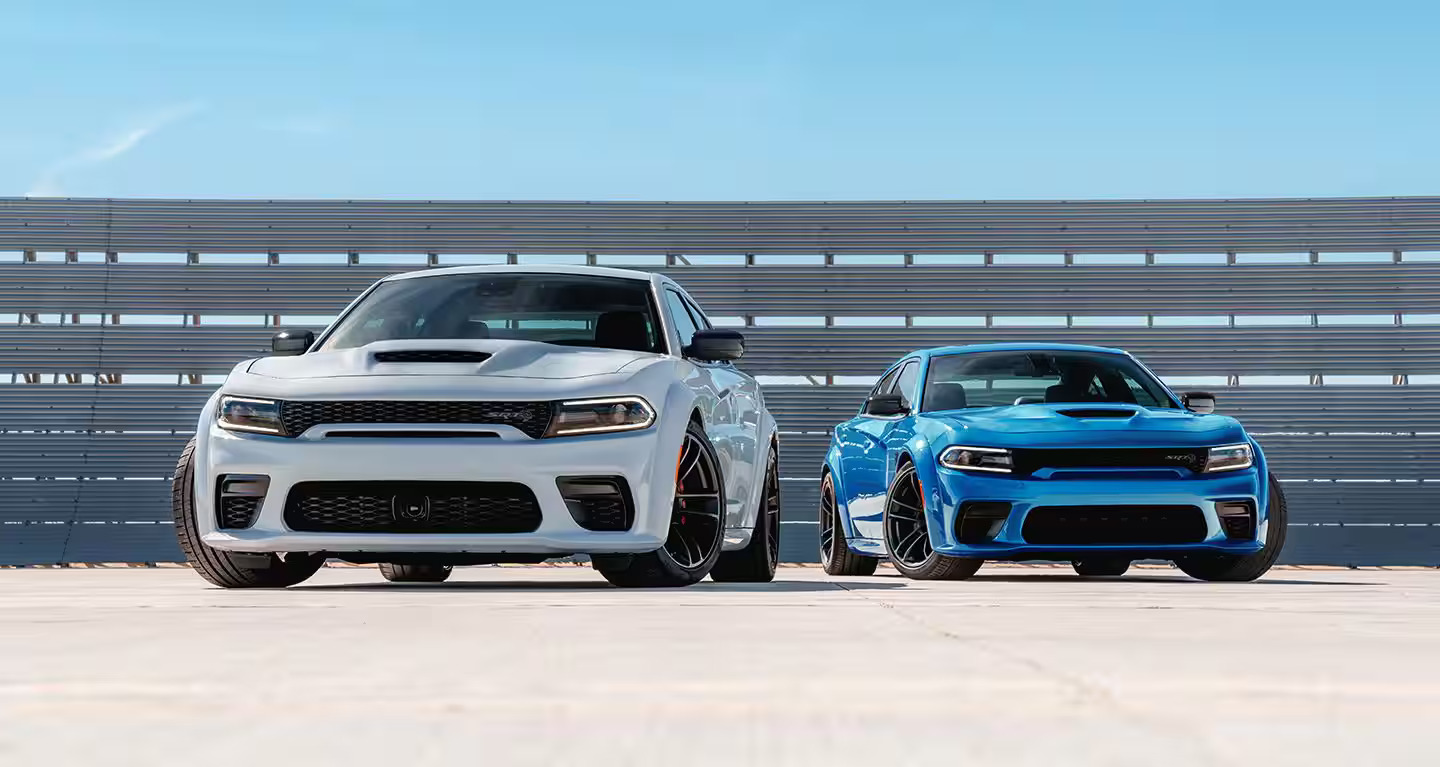 Two Dodge Chargers sitting parked next to eachother.