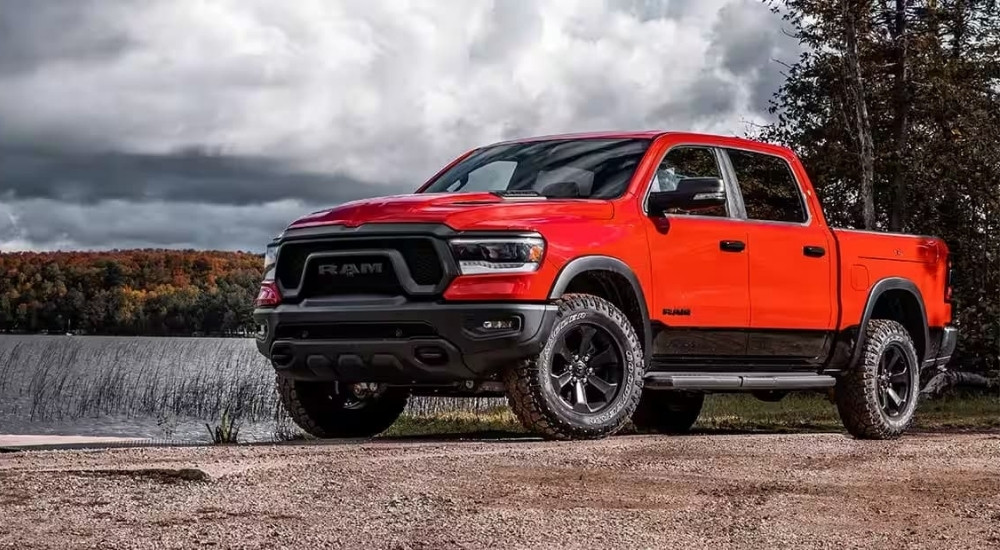 Red 2023 Ram 1500 parked near a lake