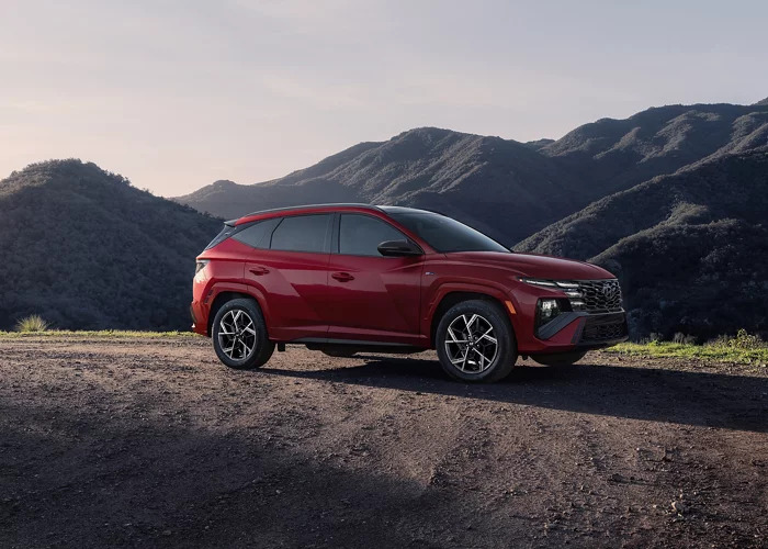 Hyundai Tucson Hybrid N-Line parked on a mountain road during sunset