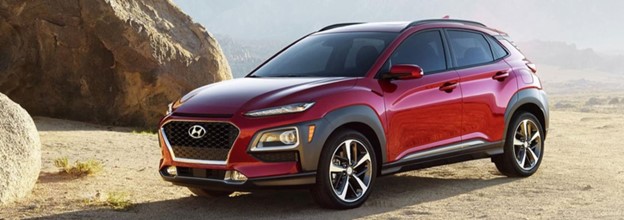 A red 2021 Hyundai Kona parked.