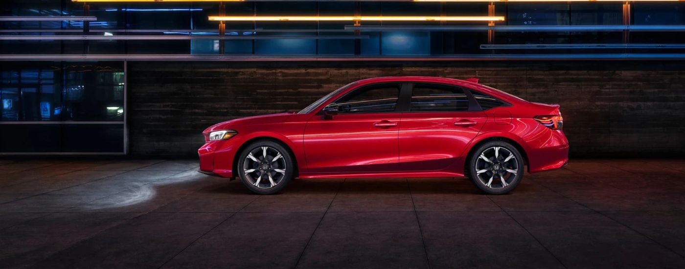 Red 2025 Honda Civic Sport from the side