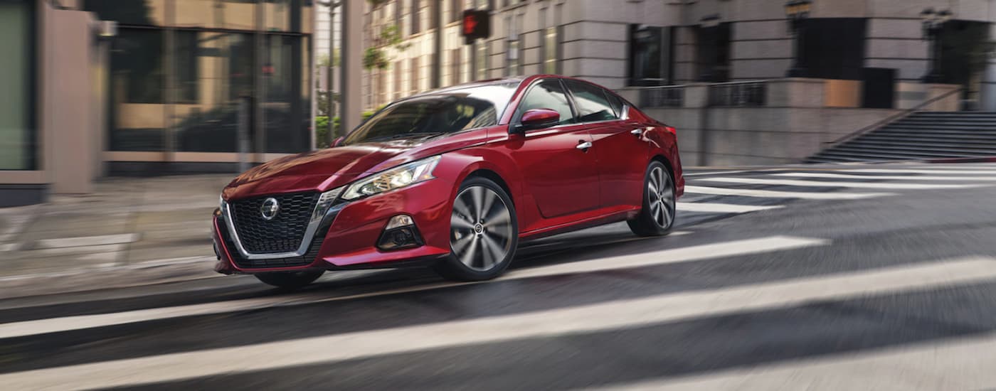 A red 2021 Nissan Altima is shown from the front at an angle.