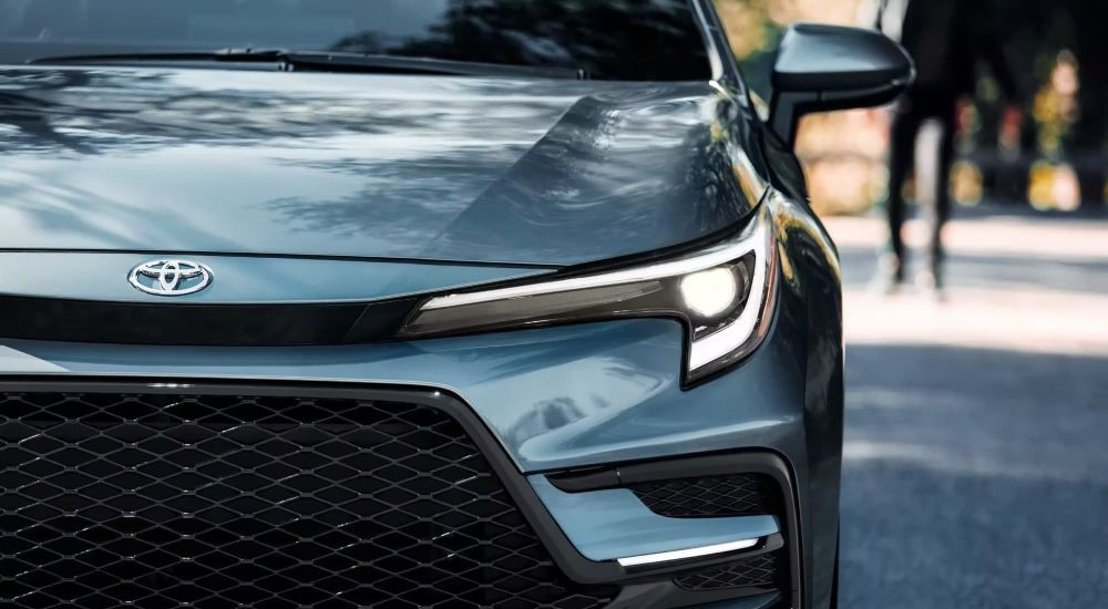 Close up of the headlight of a blue 2023 Toyota Corolla XSE.