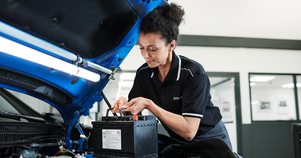 BMW technician installs a battery in a BMW