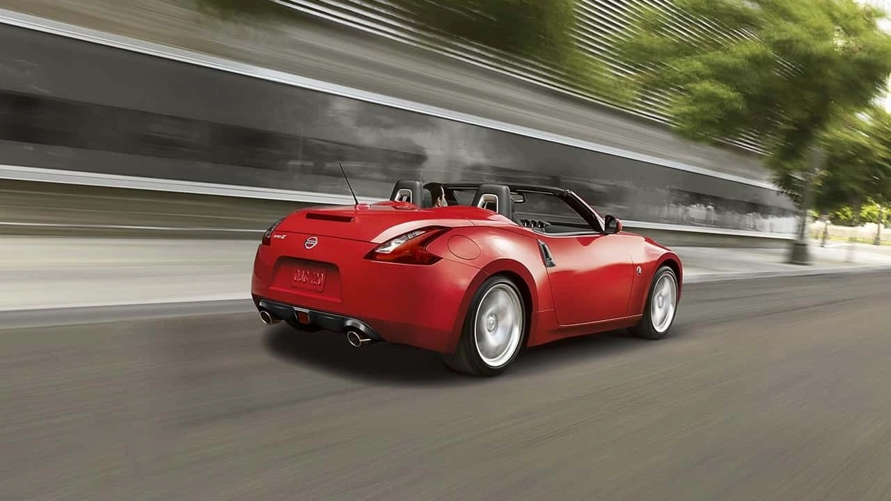 Red 2018 Nissan 370Z Roadster driving with the top down