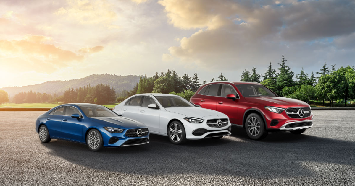 A line-up featuring a blue Mercedes-Benz CLA, a white Mercedes-Benz C-Class, and a red Mercedes-Benz GLC SUV.