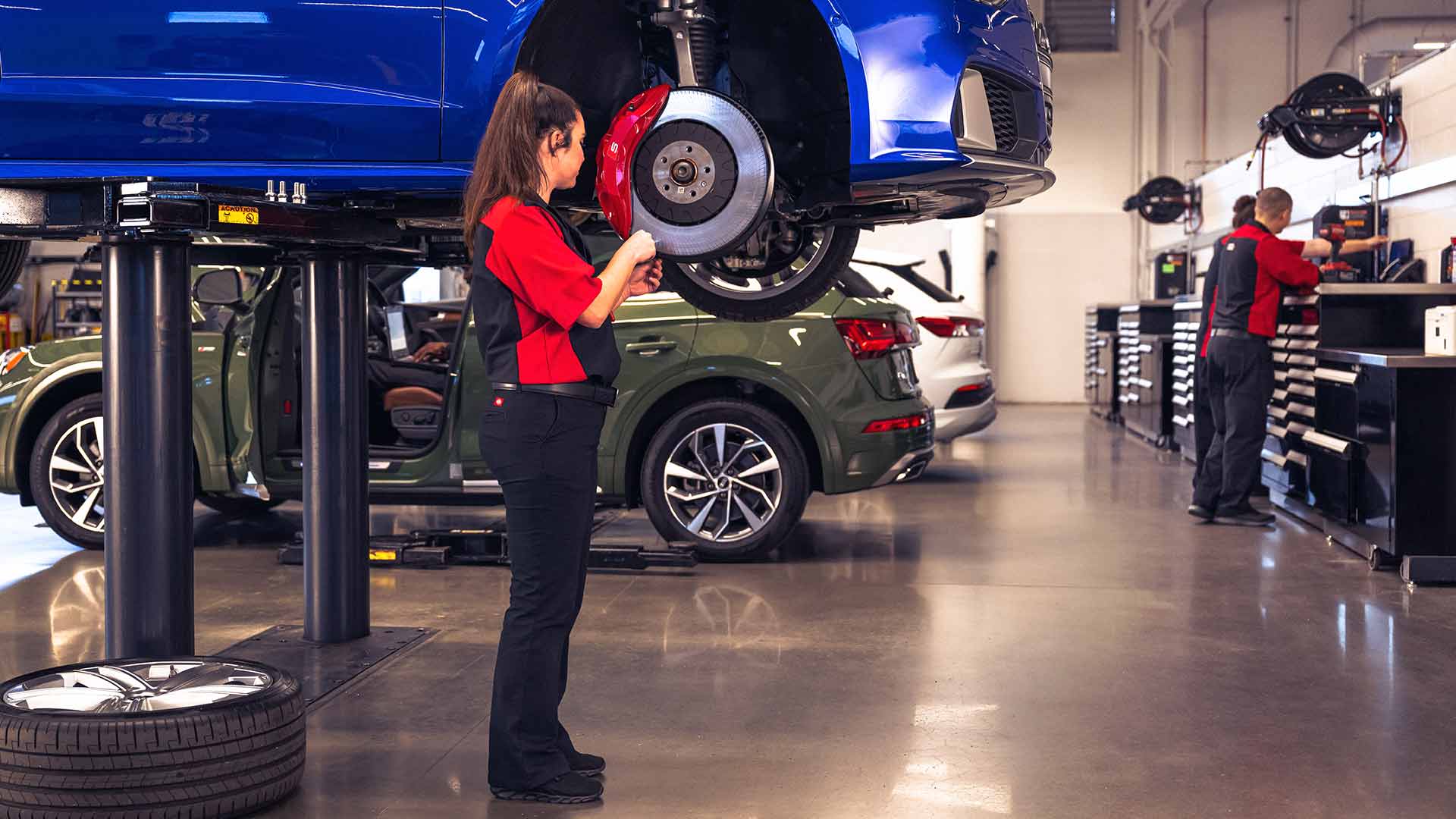 Audi service technician servicing a vehicle.