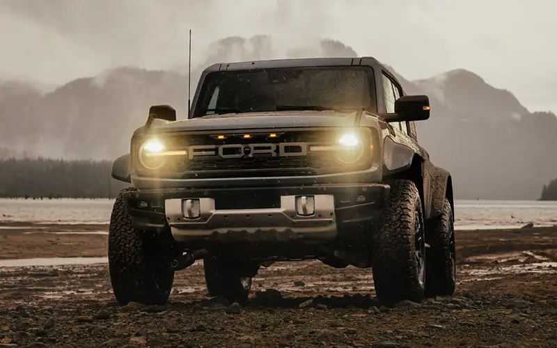 image of black ford bronco under star filled night sky