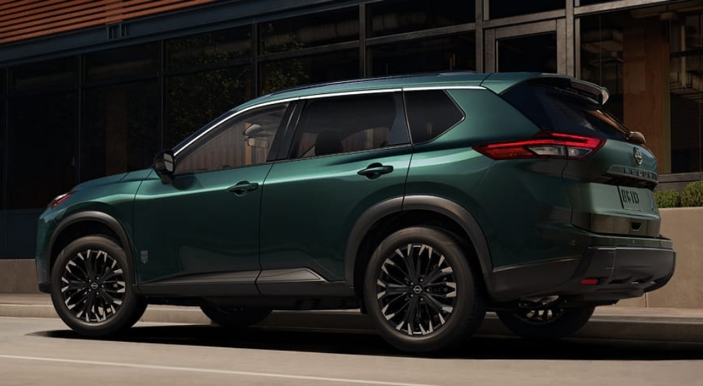 Green 2026 Nissan Rogue Dark Armor parked in front of a building