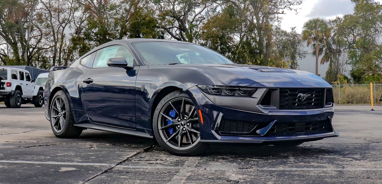 side view of an orange Ford Mustang