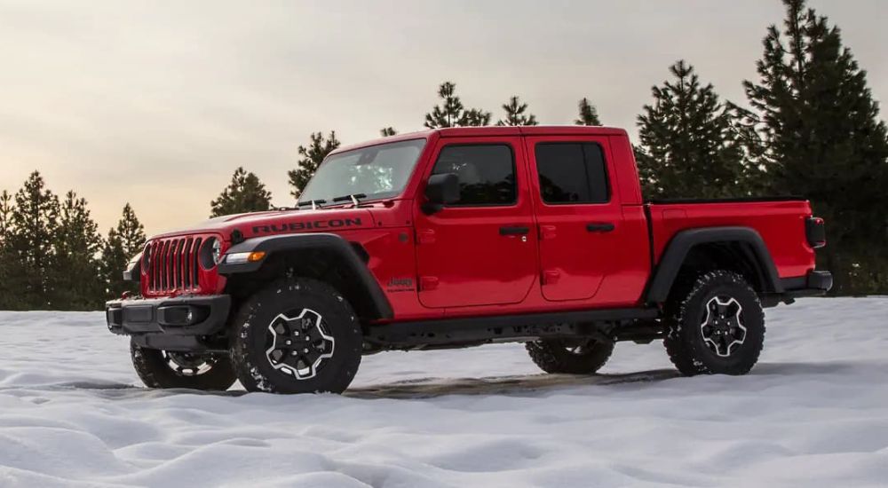 A red 2021 Jeep Gladiator Rubicon is shown parked on snow.