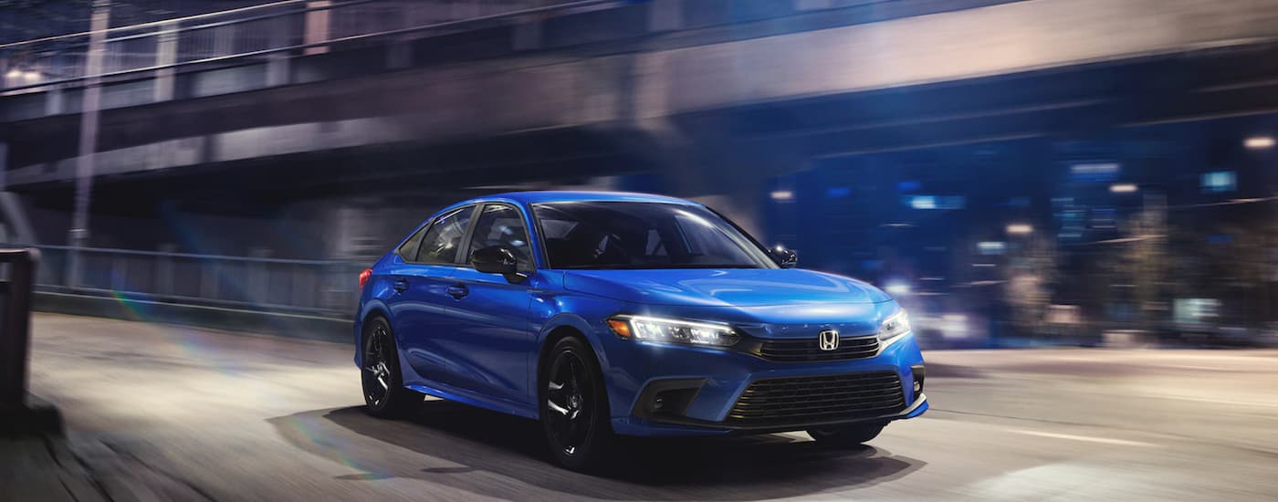 A popular used Honda car, blue 2021 Honda Civic, is shown parked on top of a parking garage.