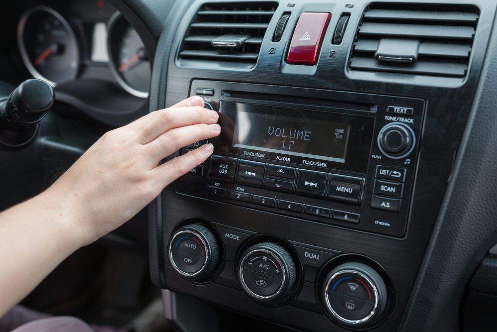 driver adjusts volume in their vehicle