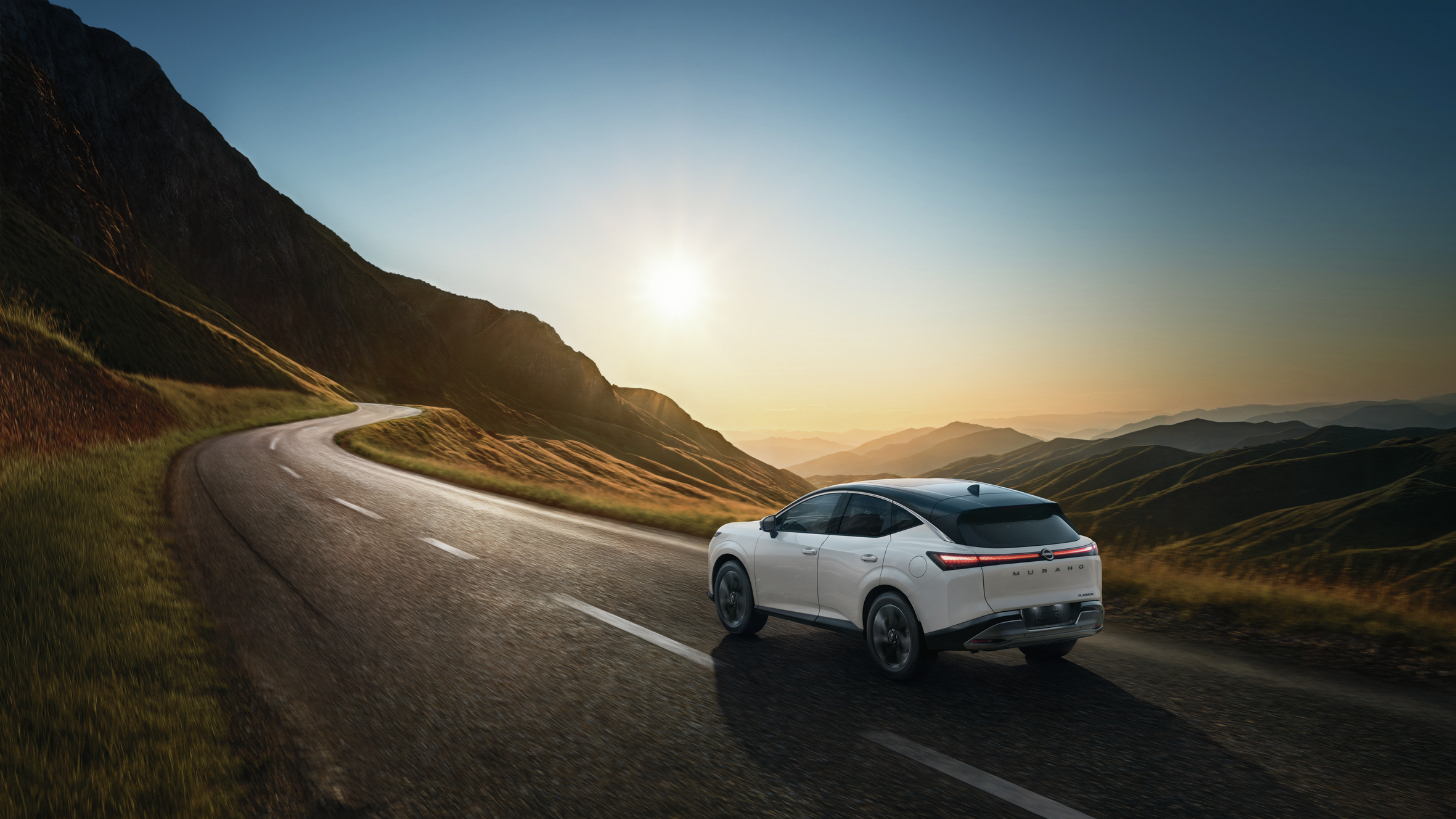 2027 Nissan Murano on an open road with mountain views.