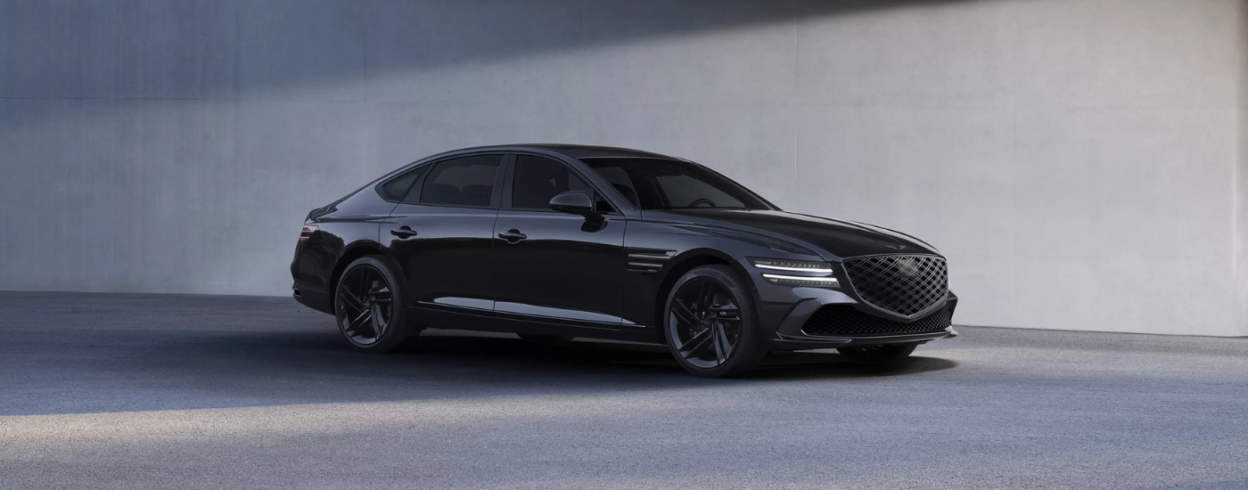Black 2026 Genesis G80 parked against a concrete wall