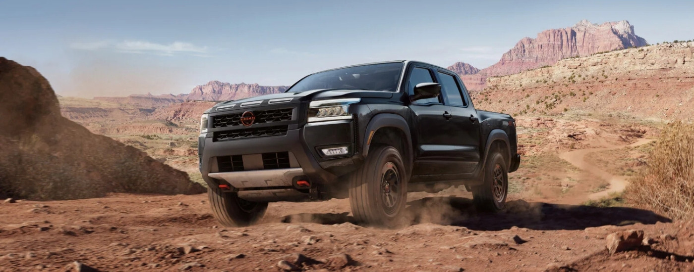 Black 2025 Nissan Frontier PRO-4X kicking up dust