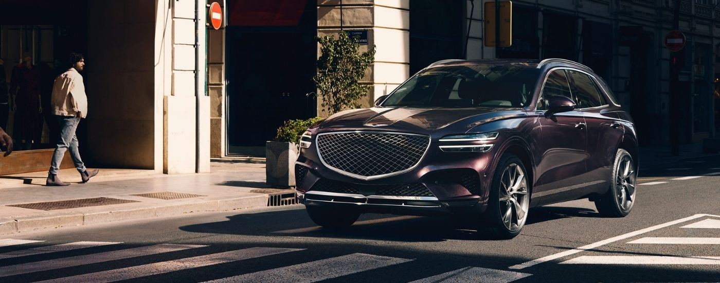 Black 2023 Genesis GV70 on a city street