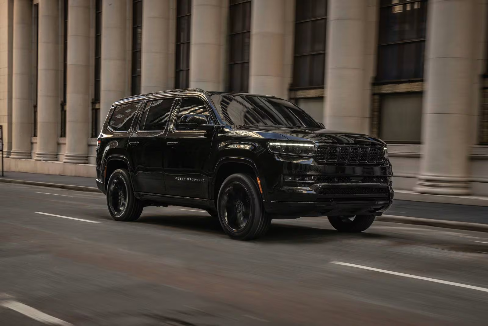 A black suv driving on the road.